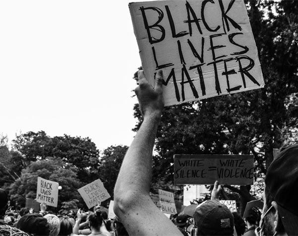 crowd holding signs during protest